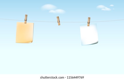 Empty notebook Hanging on the rope with wooden clip sky background.
