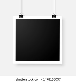 Empty photo frame hanging on a clip. Digital snapshot image. Template or mockup for design.