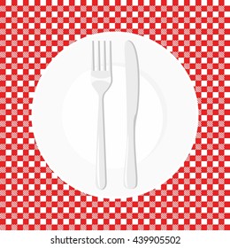 Empty plate with knife and fork. Dish fork and knife on a red tablecloth in a cage