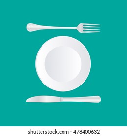 Empty plate with spoon, knife and fork