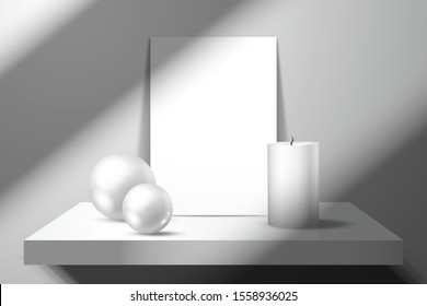 An empty sheet of paper or a greeting card, a white candle and two shiny balls are on the shelf. Mockup for design with realistic shadows
