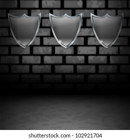 Empty Shields on dirty brick wall