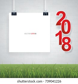 Empty white paper with 2018 Happy New Year symbol on brick wall background and green grass. Vector illustration.