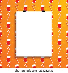 Empty white paper blank over background with Christmas canes, socks and stars