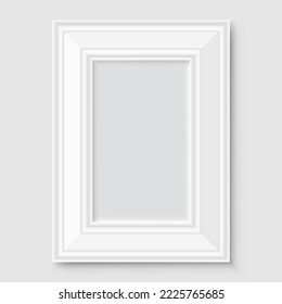 Empty white photo frame with shadow on gray wall.