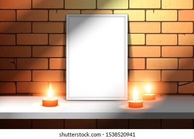 An empty white picture frame on a shelf near a brick wall with candles. Mockup for design