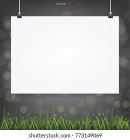 Empty white poster paper in green field area with light bluured bokeh in dark background. Vector illustration.