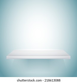 Empty white shelf hanging on a wall.