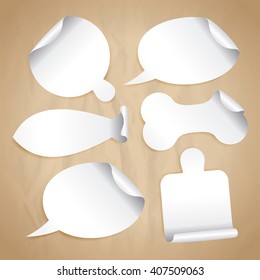 Empty white stickers on a paper - speech bubbles, board for pizza, cutting board, bone for pet, fish silhouette.