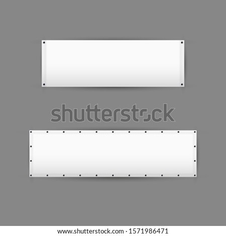 Empty white vinyl banners with grommets. Horizontal blank advertising banners isolated on grey background.