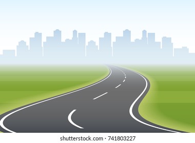 Empty winding road to city on horizon