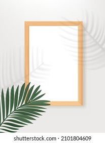 Marco de madera vacío en la mesa con sombras de hojas de palma. 3.ᵉʳ paro vertical vectorial para el diseño