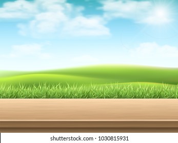 Empty wooden table on landscpe with grass background. Deck made of wooden planks. Template for a variety of products.