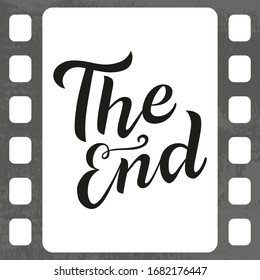 The End Black Lettering Text On Film Tape Background. Handmade Calligraphy Vector Illustration. Vector Design For Poster, Logo, Decor, Movie, Cinema, Card, Banner, Postcard, Final Credits And Print.