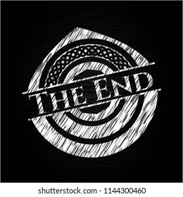 The End chalk emblem written on a blackboard