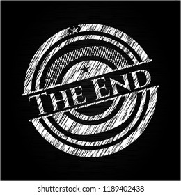 The End chalkboard emblem written on a blackboard