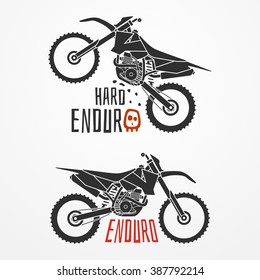 Enduro motorcycle logo in silhouette style. Four-stroke enduro motorcycle with sample text. Hard enduro motorcycle vector stock illustration. Set of two enduro motorcycle emblems.