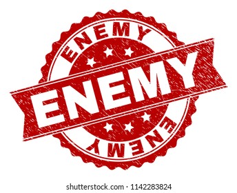 ENEMY seal print with distress texture. Rubber seal imitation has circle medal form and contains ribbon. Red vector rubber print of ENEMY title with corroded texture.