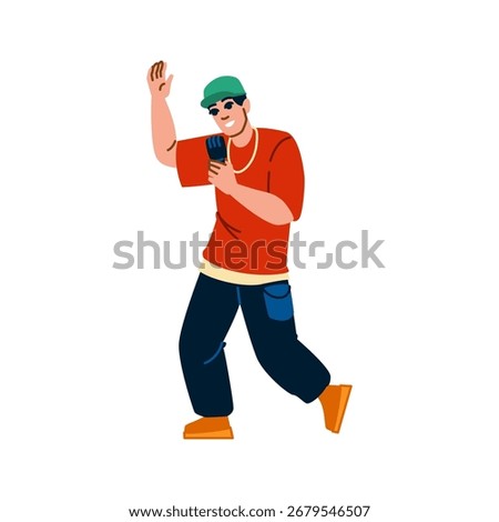 Energetic rapper wearing a red t shirt, a green baseball cap, a gold chain and dark blue trousers is performing with a microphone in hand, raising the other hand and smiling