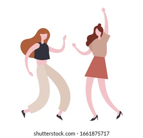 Energetic women dancing together during party. Stylish female friends in casual clothes dancing energetically together while having fun during modern party party together on weekend day