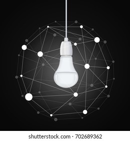 An energy saving light bulb hanging on a wire and a ball of dots and lines around it on a black background