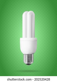 Energy saving light bulb on green background