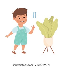 English Subject Pronoun with Funny Boy Demonstrating It Word Indicating Flower in Pot Vector Illustration