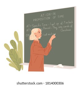 English teacher writes on a chalkboard. Foreign language lesson