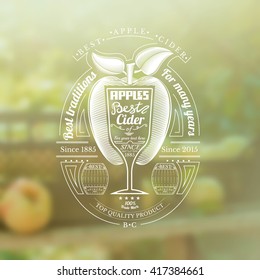 Engraving style apple with wineglass for text in the center. Silhouette Cider label on blurred photo