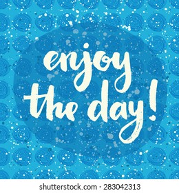 Enjoy the day! Hand lettering quote on a creative vector background