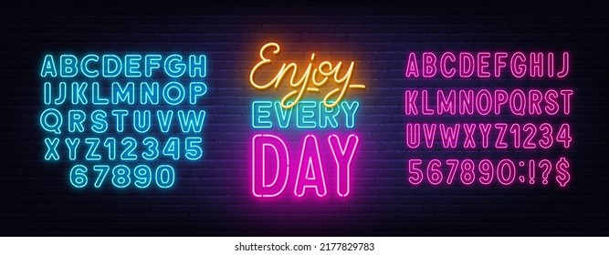 Enjoy Every day neon quote on brick wall background.