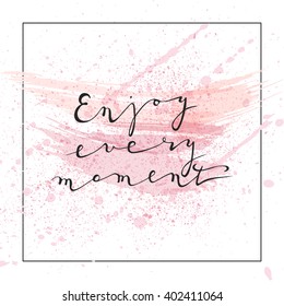 Enjoy every moment handwritten ink lettering. Black text on white background with paint splashes.