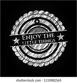 Enjoy the little things chalkboard emblem written on a blackboard