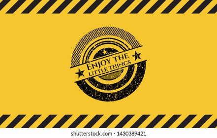 Enjoy the little things grunge black emblem with yellow background, warning sign. Vector Illustration. Detailed.