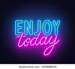 Enjoy today neon lettering on brick wall background.
