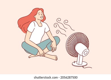 Enjoying cool wind waves concept. Young smiling woman cartoon character sitting on floor catching enjoying cool wind from fan vector illustration 