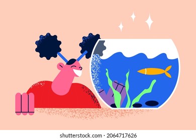 Enjoying home pets life concept. Smiling happy girl cartoon character standing looking at home golden fish in aquarium vector illustration 