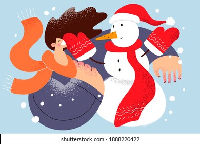 Enjoying wintertime and snow concept. Young smiling cheerful woman in scarf playing with snowman and enjoying being on nature outdoors and winter holidays celebration vector illustration 