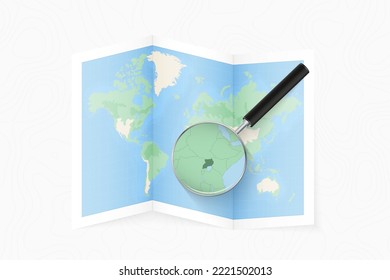Enlarge Uganda with a magnifying glass on a folded map of the world. Vector paper map.