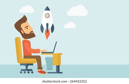 An enthusiastic, eager hipster Caucasian young man with beard sitting in front of his laptop browsing, researching  and planning a metaphor for new business. On-line start up business concept. A