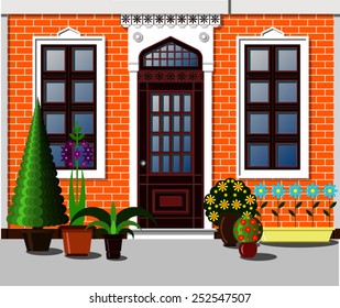 entrance to the house decorated with potted plants