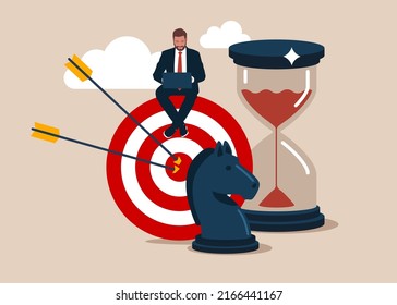 Entrepreneur working with computer sit on target with chess knight and sandglass. Business strategy, planning to achieve goal, management for company growth opportunity, market success goal.