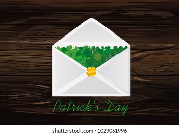 Envelope with green clover inside. St.Patrick 's Day. Vector illustration. Greeting card with empty space for text or advertising. On wooden background.