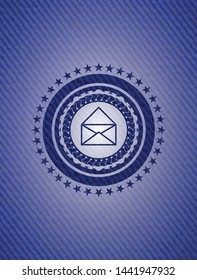 envelope icon inside badge with denim background