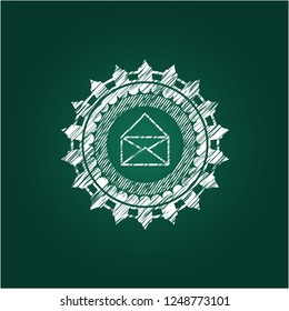 envelope icon inside chalk emblem written on a blackboard