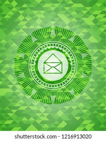 envelope icon inside green emblem with triangle mosaic background