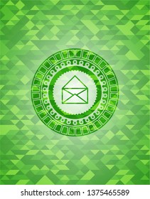 envelope icon inside green emblem with mosaic background