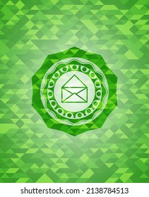 envelope icon inside realistic green mosaic emblem. 