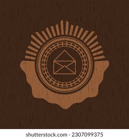 envelope icon inside retro wood emblem. 