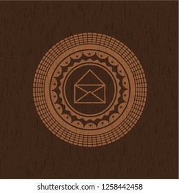 envelope icon inside wood badge or emblem